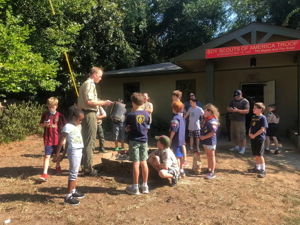 Scouts and leaders gathered outside the scout hut